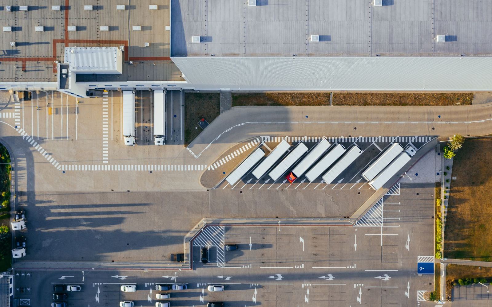 A distribution centre seen from above, trucks at the loading docks